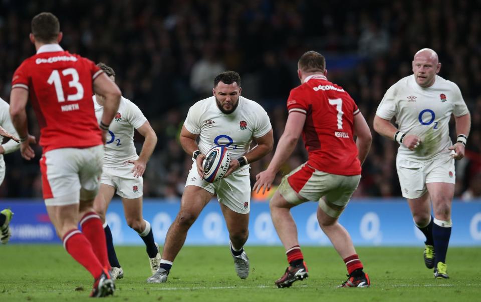 Ellis Genge of England runs with the ball while under pressure from Tommy Reffell of Wales during the Guinness Six Nations 2024 match between England and Wales at Twickenham Stadium on February 10, 2024 in London, England