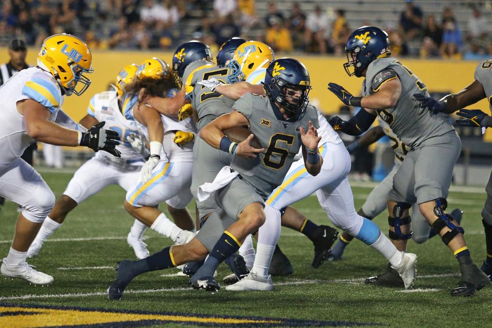 West Virginia quarterback Garrett Greene (6) runs against Long Island during the second half of an NCAA college football game in Morgantown, W.Va., Saturday, Sept., 11, 2021. (AP Photo/Kathleen Batten)