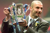 FILE - Chelsea's player and manager Gianluca Vialli celebrates with the Coca-Cola Cup trophy after his Chelsea team beat Middlesbrough 2-0 in the final at London's Wembley stadium, Sunday, March 29, 1998. Gianluca Vialli, the former Italy striker who helped both Sampdoria and Juventus win Serie A and European trophies before becoming a player-manager at Chelsea, has died on Friday, Jan. 6, 2023. He was 58. (AP Photo/Max Nash, File)
