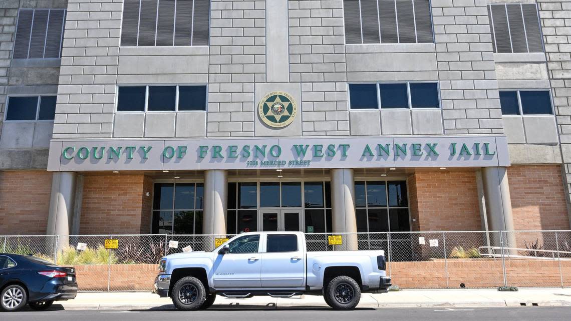 The entrance to the new Fresno County West Annex Jail building in downtown Fresno is still closed off with a chain link fence on Wednesday, May 8, 2024 but officials say the building could finally open by the end of the month.