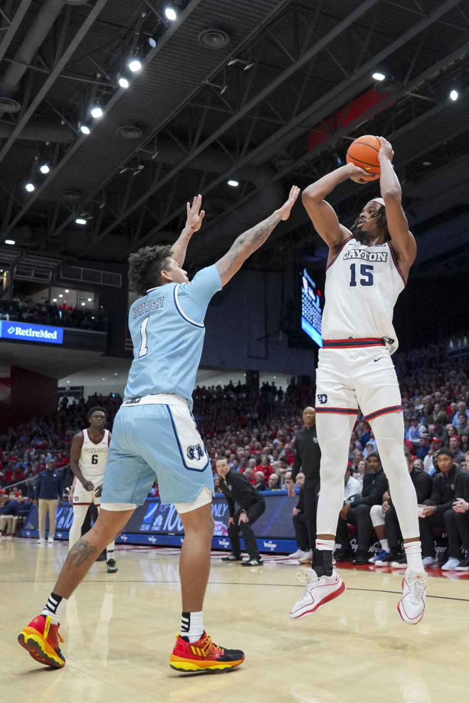 Dayton forward DaRon Holmes II, right, shoots over Rhode Island guard Luis Kortright during the first half of an NCAA college basketball game, Saturday, Jan. 20, 2024, in Dayton, Ohio. (AP Photo/Aaron Doster)