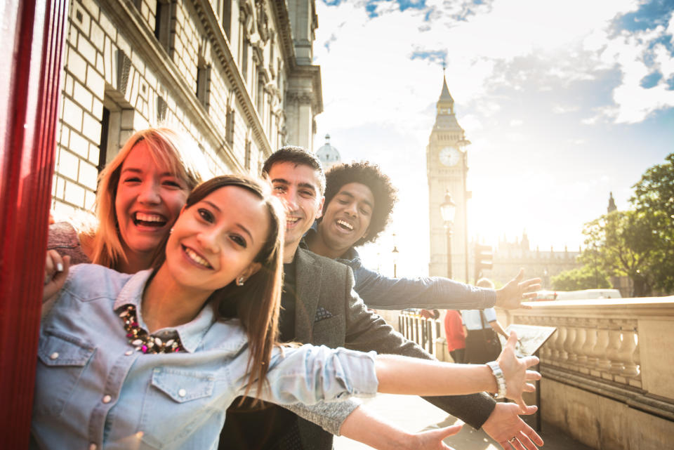 Happy tourist group of friends in London, England