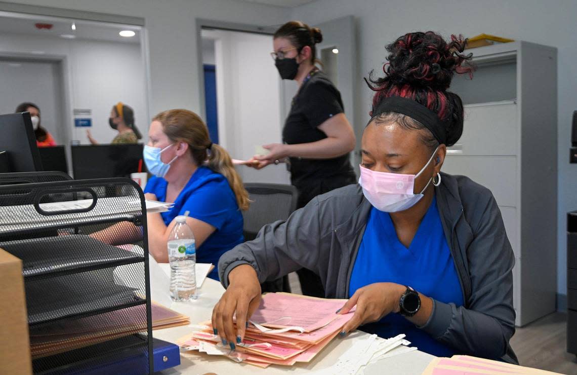 Priscilla Jones, left, and Janisha Lopez work at the reception desk of the new Planned Parenthood clinic in Kansas City, Kansas. The health center is getting more requests for abortion services than it can handle.
