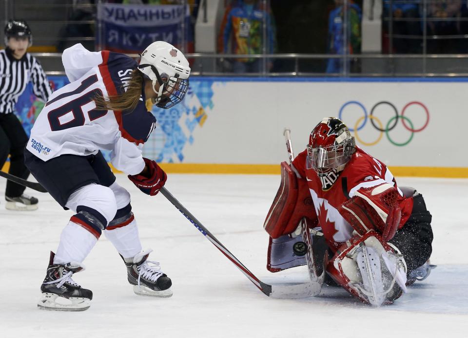 Canada's goalie Labonte makes a save on Team USA's Stack during the second period of their women's ice hockey game at the Sochi 2014 Sochi Winter Olympics