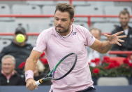 Stan Wawrinka, of Switzerland, plays a shot to Emil Ruusuvuori, of Finland, during round one play at the National Bank Open tennis tournament in Montreal, Monday, Aug. 8, 2022. (Graham Hughes/The Canadian Press via AP)