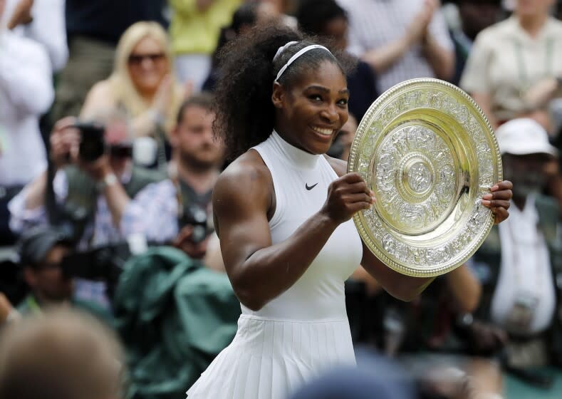 FILE - Serena Williams of the U.S holds her trophy after winning the women's singles final against Angelique Kerber of Germany on day thirteen of the Wimbledon Tennis Championships in London, Saturday, July 9, 2016. Serena Williams is going to play at Wimbledon this year, after all. The All England Club announced via Twitter on Tuesday, June 14, 2022, that Williams was awarded a wild-card entry for singles.(AP Photo/Ben Curtis, File)