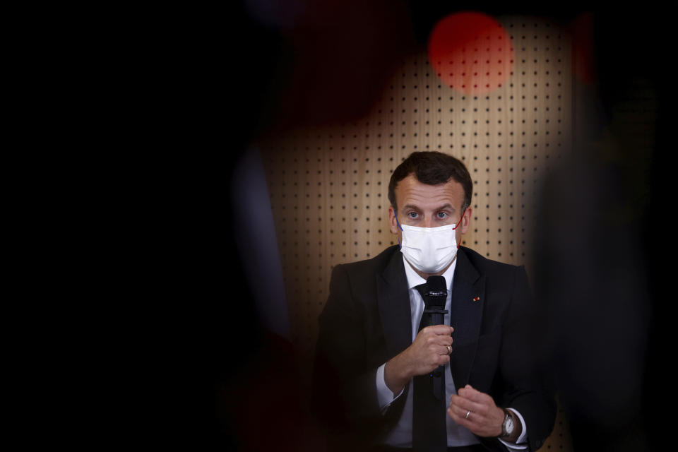 French President Emmanuel Macron, wearing a protective face mask, talks during a meeting with medical staff members during a visit in a child psychiatry department at Reims hospital, eastern France, to discuss the psychological impact of the COVID-19 crisis and the lockdown on children and teenagers in France, Wednesday, April 14, 2021. (Christian Hartmann/Pool via AP)