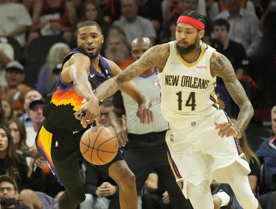 Apr 26, 2022; Phoenix, Ariz, U.S.;  Phoenix Suns forward Mikal Bridges (25) fights for the ball with New Orleans Pelicans forward Brandon Ingram (14) during Game 5 of the Western Conference playoffs.