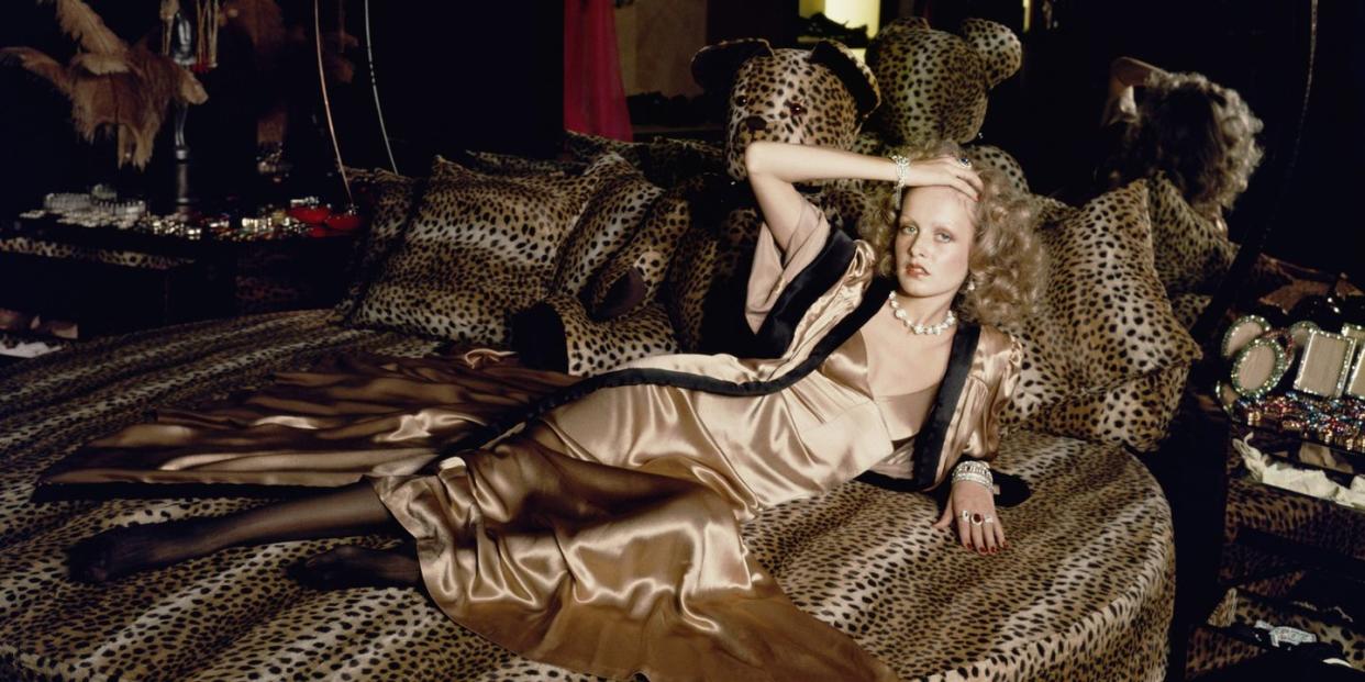 english model twiggy stretches out on a leopardskin bed at biba's kensington store, 1971