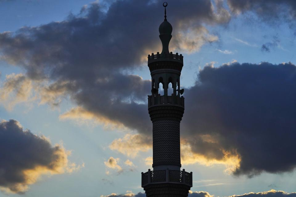 A minaret of a mosque is seen at sunset in Dubai, United Arab Emirates, Saturday, Dec. 4, 2021. (AP Photo/Jon Gambrell)