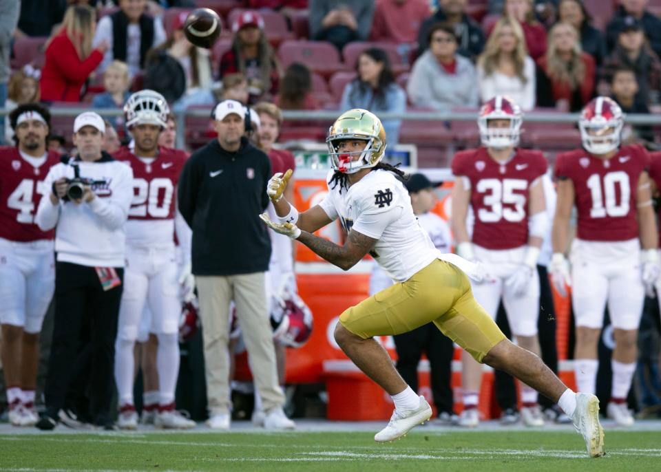 November 25, 2023;  Stanford, California, USA;  Notre Dame Fighting Irish wide receiver Rico Flores Jr. (17) catches a pass from quarterback Sam Hartman during the first quarter at Stanford Stadium.  Mandatory Credit: D. Ross Cameron-USA TODAY Sports