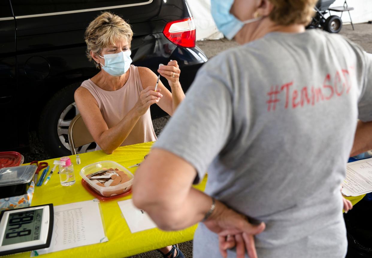 Dee Kirby, a registered nurse with the Sangamon County Department of Public Health, prepares doses of the Pfizer COVID-19 vaccine in the drive-thru COVID-19 vaccine clinic at the Sangamon County Department of Public Health in Springfield, Ill., Tuesday, July 27, 2021. [Justin L. Fowler/The State Journal-Register] 