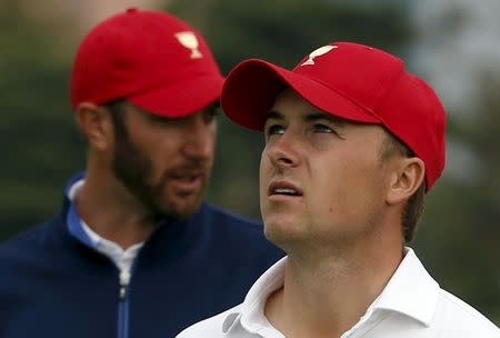 U.S. team members Jordan Spieth (R) and Dustin Johnson walk on the 16th hole during their foursome matches of the 2015 Presidents Cup golf tournament at the Jack Nicklaus Golf Club in Incheon, South Korea, October 10, 2015. REUTERS/Toru Hanai