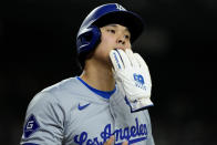 Los Angeles Dodgers' Shohei Ohtani (17) walks to the dugout after scoring on a ground rule double hit by Teoscar Hernández during the fifth inning of a baseball game against the Arizona Diamondbacks, Monday, April 29, 2024, in Phoenix. (AP Photo/Matt York)