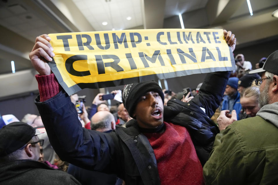 A protester interrupts Republican presidential candidate former President Donald Trump speaks at a rally at Simpson College in Indianola, Iowa, Sunday, Jan. 14, 2024. (AP Photo/Andrew Harnik)