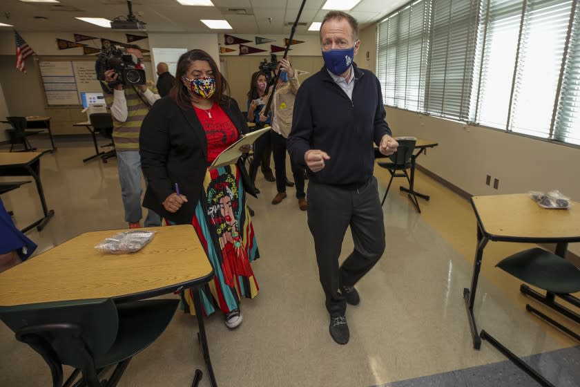 Panorama City, CA - March 10: Superintendent Austin Beutner, right, and UTLA President Cecily Myart-Cruz tour a classroom to see the seating arrangements under COVID-19 restrictions at Panorama High School on Wednesday, March 10, 2021 in Panorama City, CA.(Irfan Khan / Los Angeles Times)