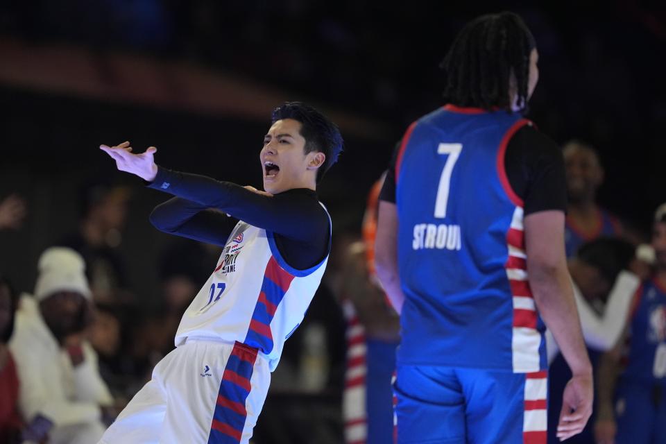 Actor Dylan Wang reacts near NFL player CJ Stroud after hitting a 3-point shot during the second half of the NBA basketball All-Star Celebrity Game, Friday, Feb. 16, 2024, in Indianapolis. (AP Photo/Darron Cummings)