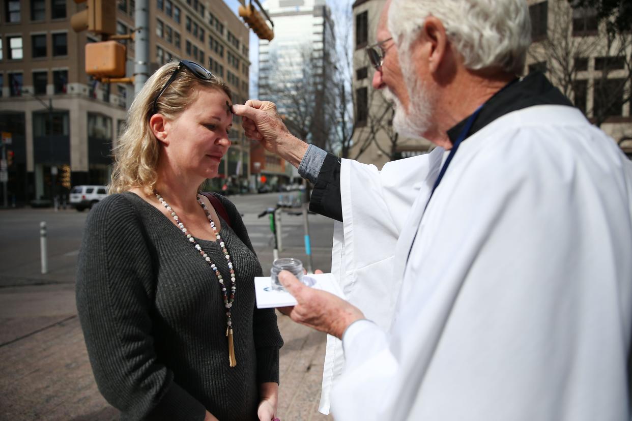 Emily Porter receives ashes from parishioner Rick Patrick with St. David's Episcopal Church at the corner of West Sixth Street and Guadalupe Street last Ash Wednesday.