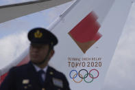 A plane carrying the Olympic flame arrives before Olympic Flame Arrival Ceremony at Japan Air Self-Defense Force Matsushima Base in Higashimatsushima in Miyagi Prefecture, north of Tokyo, Friday, March 20, 2020. The Olympic flame from Greece is set to arrive in Japan even as the opening of the the Tokyo Games in four months is in doubt with more voices suggesting the games should to be postponed or canceled because of the worldwide virus pandemic. (AP Photo/Eugene Hoshiko)