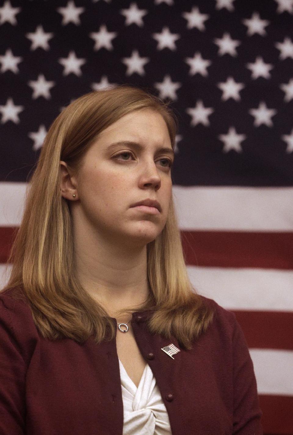 Plaintiff Zoe Bedell, who is a Captain in the U.S. Marine Corps reserves, listens during a media conference Tuesday, Nov. 27, 2012, in San Francisco. Several active women military personnel have filed a federal lawsuit to demand combat action, requesting all branches of the military to remove the so-called combat exclusionary rule that bars women from fighting on the front lines. This suit, to be filed by the American Civil Liberties Union, is believed to be the first involving active duty military personnel. (AP Photo/Ben Margot)