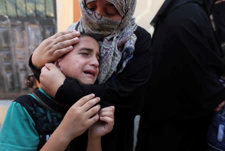 Relatives of Palestinian Hamas member Abed Alkareem Redwan, who was killed in an Israeli air strike, mourn during his funeral in Rafah in the southern Gaza Strip July 20, 2018. REUTERS/Ibraheem Abu Mustafa