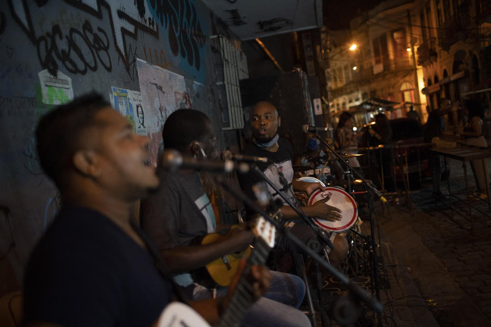 Brazilian band Atitude Nossa plays samba at a street as the restrictions related to the COVID-19 pandemic are eased in Rio de Janeiro, Brazil, Monday, Oct. 5, 2020. Since the beginning of October, live shows are now permitted in Rio de Janeiro. (AP Photo/Silvia Izquierdo)