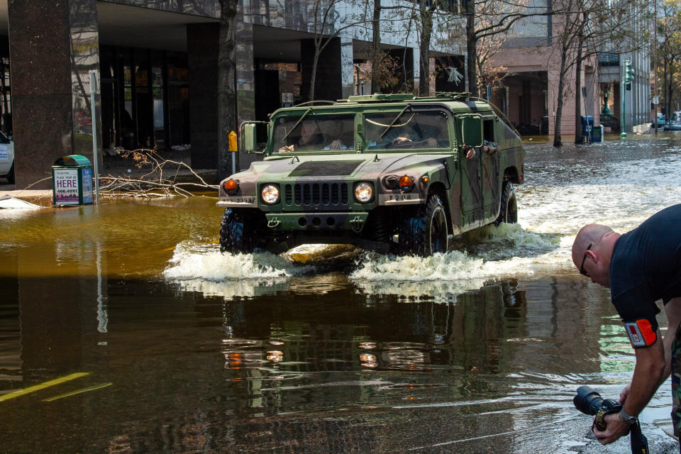 A Humvee splashes through floodwaters in the central business district of New Orleans in the aftermath of Hurricane Katrina in September 2005.