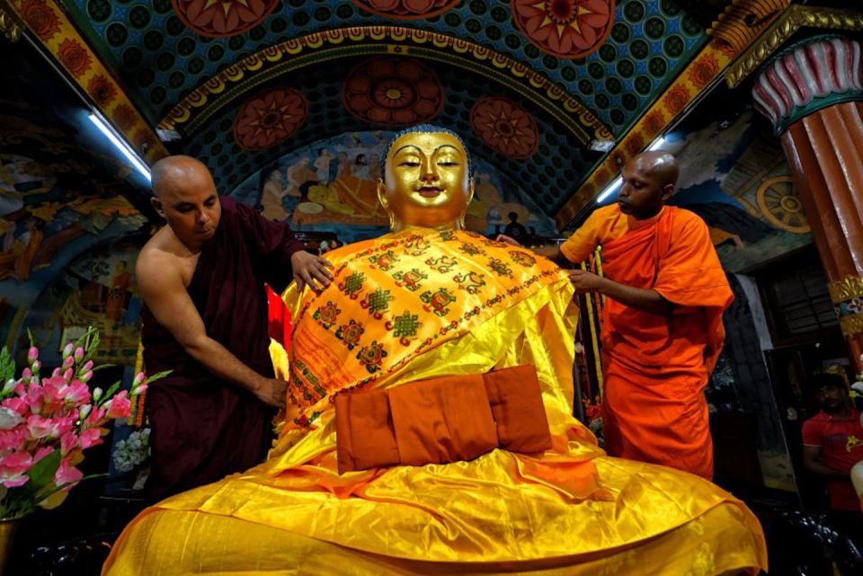 Buddhist monks in Kolkata, India, prepare a statue of the Buddha during the Buddha Pūrṇimā festival. <a href="https://www.gettyimages.com/detail/news-photo/buddhist-monks-preparing-the-statue-of-gautama-buddha-at-news-photo/1252924648?adppopup=true" rel="nofollow noopener" target="_blank" data-ylk="slk:Avishek Das/SOPA Images/LightRocket via Getty Images;elm:context_link;itc:0;sec:content-canvas" class="link ">Avishek Das/SOPA Images/LightRocket via Getty Images</a>