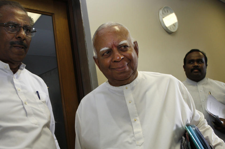 FILE- Sri Lanka's ethnic Tamil minority political party Tamil National Alliance leader Rajavarothiam Sampanthan, right, leaves with fellow lawmakers Mavai Senadirajah, left, and Selvam Adeiakalanadan, back right after a media conference in Colombo, Sri Lanka, June 9, 2010. Sampanthan, a senior ethnic Tamil leader and lawmaker, who became the face of the minority community's campaign for autonomy in Sri Lanka since the end of a brutal quarter-century civil war, has died. He was 91. (AP Photo/Eranga Jayawardena, File)