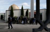 FILE PHOTO: A policeman stands guard as members of the Muslim community visit Al-Noor mosque after it was reopened in Christchurch