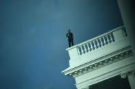 A member of the US Secret Service takes up position on the roof as the White House is locked down in Washington, DC, on August 10, 2020. - Secret Service guards shot a person, who was apparently armed, outside the White House on August 10, 2020. President Donald Trump said just after being briefly evacuated in the middle of a press conference. (Photo by Brendan Smialowski / AFP) (Photo by BRENDAN SMIALOWSKI/AFP via Getty Images)