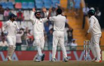 Cricket - India v England - Third Test cricket match - Punjab Cricket Association Stadium, Mohali, India - 29/11/16 - India's Virat Kohli and Mohammed Shami celebrate the dismissal of England's Adil Rashid. REUTERS/Adnan Abidi
