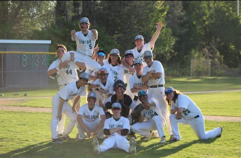 The Spackenkill baseball team poses on its home field in celebration after winning a Section 9 Class B semifinal on May 25, 2022.