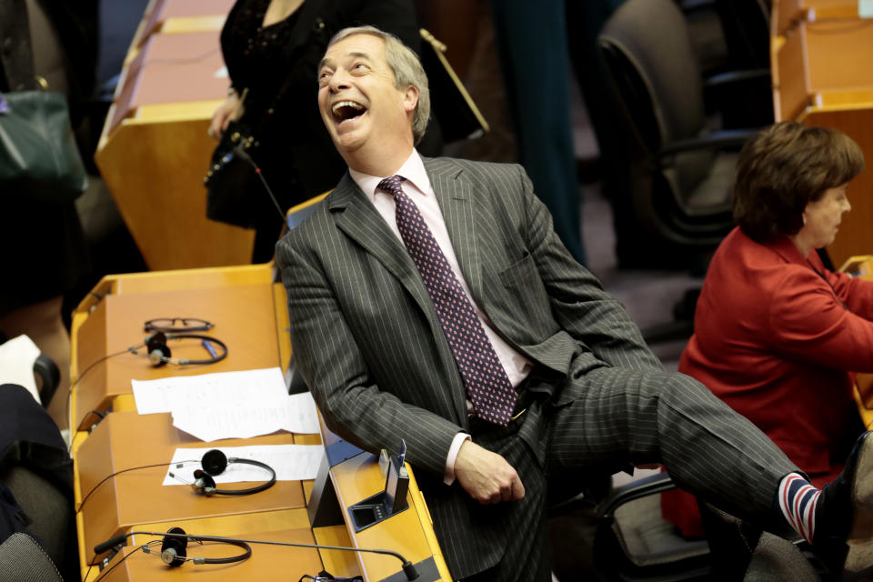 Brexit Party leader Nigel Farage, shows off his Union flag socks ahead of a vote on the UK's withdrawal from the EU during the plenary session at the European Parliament in Brussels, Wednesday, Jan. 29, 2020. The U.K. is due to leave the EU on Friday, Jan. 31, 2020, the first nation in the bloc to do so. (AP Photo/Virginia Mayo)