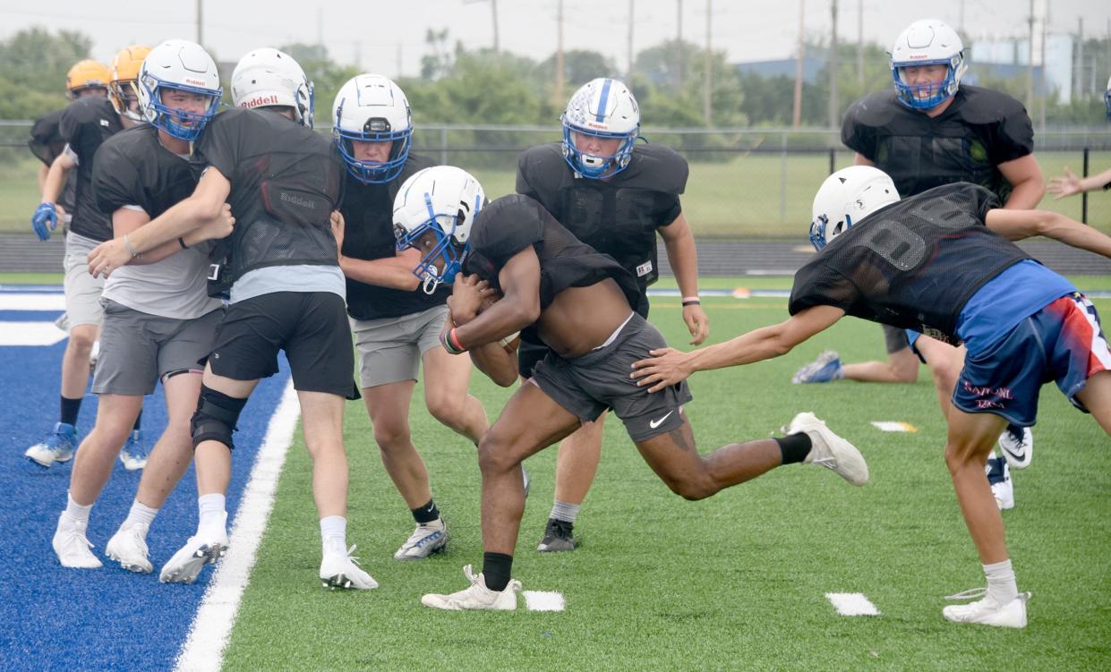 Dundee Vikings running back Trey Parker eyes the blue end zone turf field in practice inside the new John D. Craig and Family Athletic Complex.