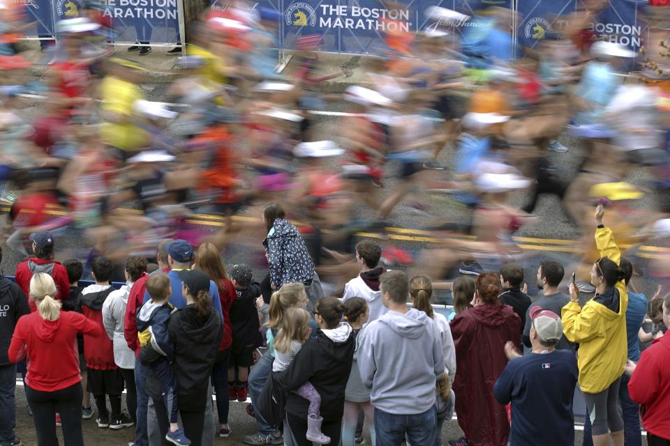 FILE - In this April 15, 2019, file photo, fans cheer on the third wave of runners at the start of the 123rd Boston Marathon in Hopkinton, Mass. Due to the COVID-19 virus pandemic, the 124th running of the Boston Marathon was postponed from its traditional third Monday in April to Monday, Sept. 14, 2020. (AP Photo/Stew Milne, File)