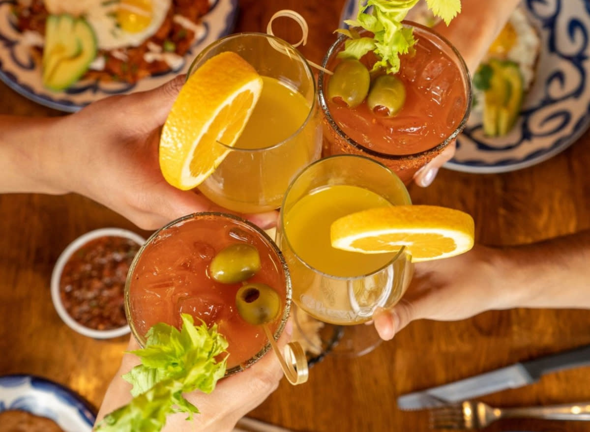 overhead shot of people clinking glasses with chevy's fresh mex cocktails