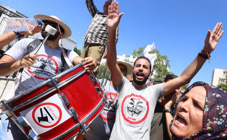 A demonstrator hits a drum during a demonstration against a bill that would protect those accused of corruption from prosecution in front of Assembly of the Representatives of the People in Tunis, Tunisia September 13, 2017. The sign reads "No. We will not forgive". REUTERS/Zoubeir Souissi REUTERS/Zoubeir Souissi