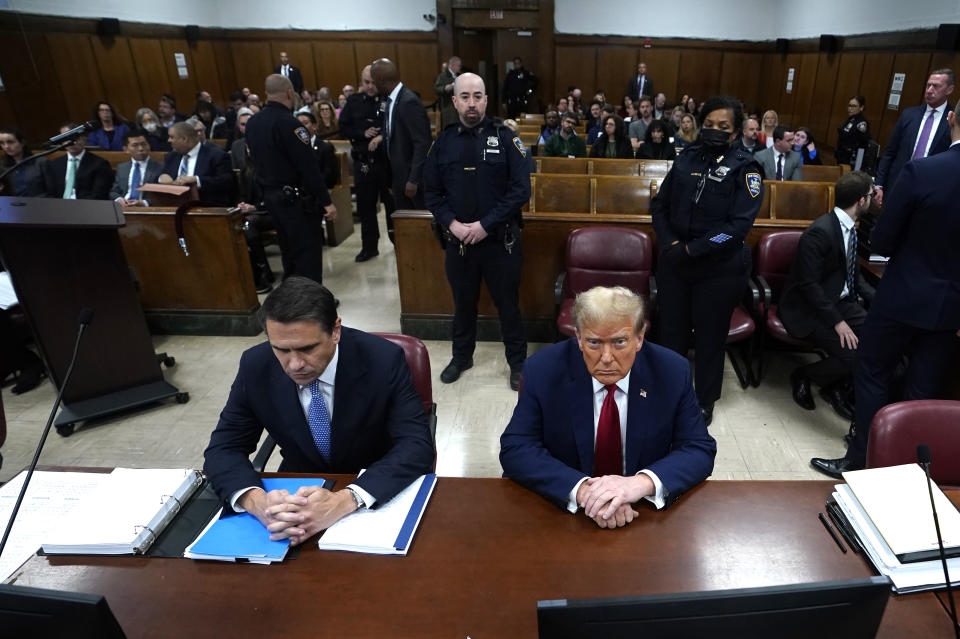 Former US President Donald Trump, right, sitting next to lawyer Todd Blanche, attends his trial for allegedly covering up hush money payments linked to extramarital affairs, at Manhattan Criminal Court in New York City, Tuesday April 23, 2024. Before testimony resumes Tuesday, the judge will hold a hearing on prosecutors' request to sanction and fine Trump over social media posts they say violate a gag order prohibiting him from attacking key witnesses. (Timothy A. Clary/Pool via AP)