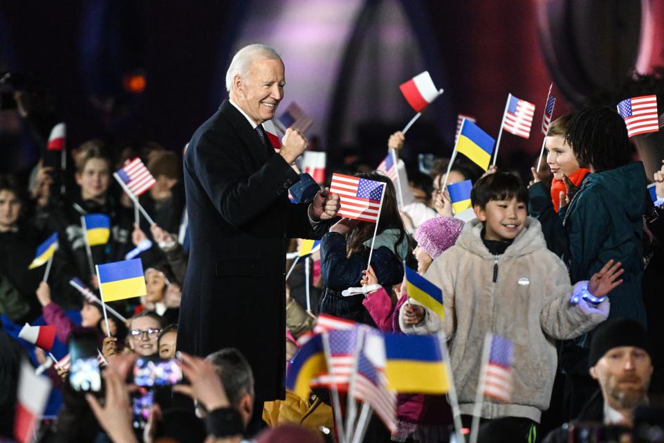 President  Joe Biden speaks with children after delivering a speech at the Royal Castle Arcades on Tuesday in Warsaw, Poland.