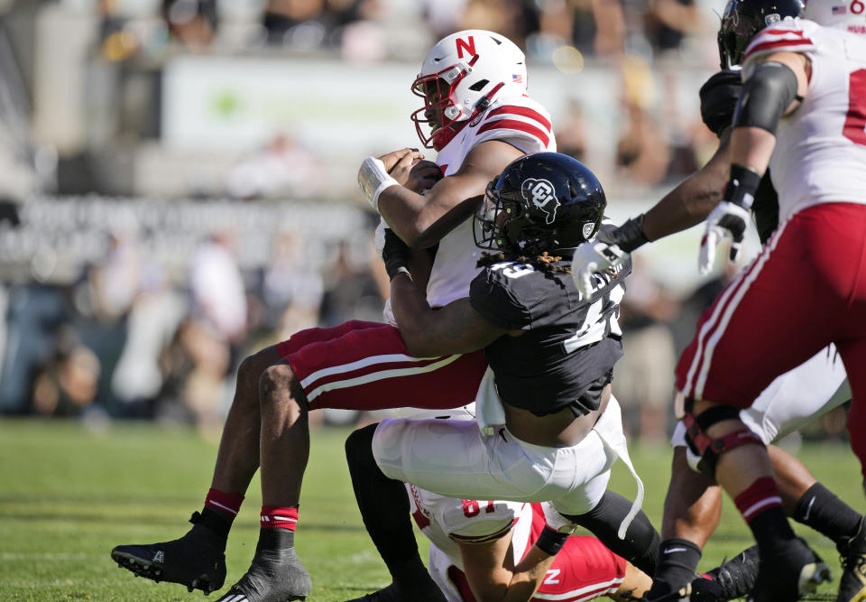 Colorado defensive end Taijh Alston, right, tackles Nebraska quarterback Jeff Sims after a short gain in the first half of an NCAA college football game Saturday, Sept. 9, 2023, in Boulder, Colo. (AP Photo/David Zalubowski)