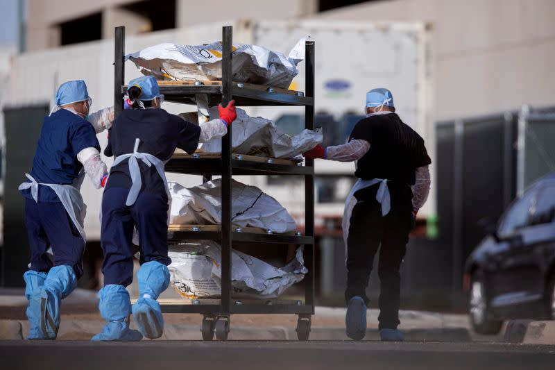 FILE PHOTO: El Paso County Medical Examiner's Office staff move bodies in El Paso