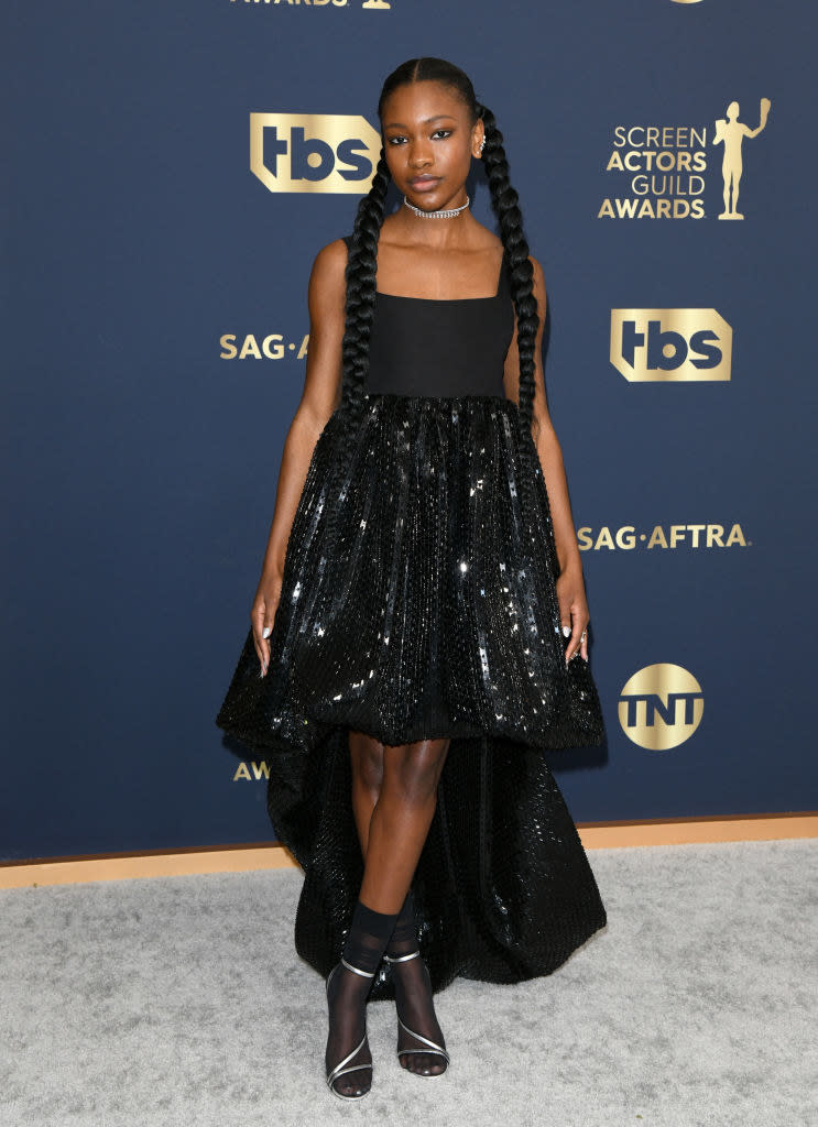 a halter dress with a sequined high-low skirt and a silver choker