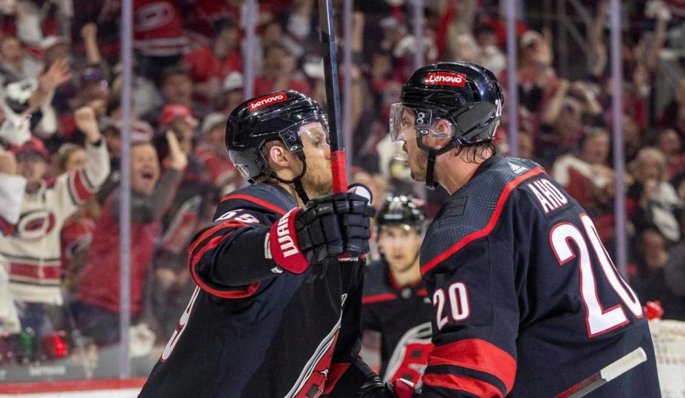 Carolina Hurricanes center <a class="link " href="https://sports.yahoo.com/nhl/players/6777/" data-i13n="sec:content-canvas;subsec:anchor_text;elm:context_link" data-ylk="slk:Sebastian Aho;sec:content-canvas;subsec:anchor_text;elm:context_link;itc:0">Sebastian Aho</a> (20) celebrates with teammate <a class="link " href="https://sports.yahoo.com/nhl/players/6057/" data-i13n="sec:content-canvas;subsec:anchor_text;elm:context_link" data-ylk="slk:Jake Guentzel;sec:content-canvas;subsec:anchor_text;elm:context_link;itc:0">Jake Guentzel</a> (59) after scoring in the first period on New York Rangers goaltender Igor Shesterkin (31) during Game 4 in the second round of the 2024 Stanley Cup playoffs on Saturday, May 11, 2024 at PNC Arena, in Raleigh N.C. Robert Willett/rwillett@newsobserver.com