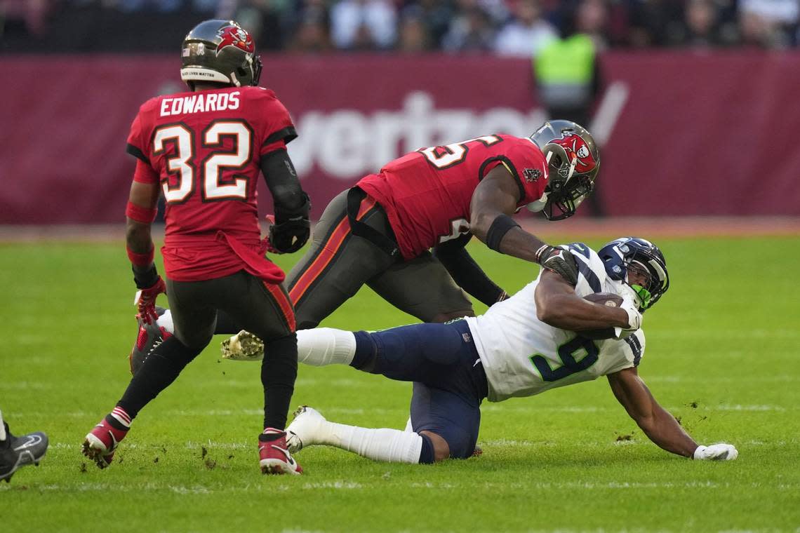 Seattle Seahawks running back Kenneth Walker III (9) is tackled by Tampa Bay Buccaneers’ Akiem Hicks during the first half of an NFL football game, Sunday, Nov. 13, 2022, in Munich, Germany. (AP Photo/Matthias Schrader)