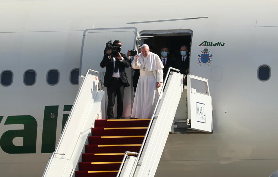 Pope Francis, font right, bids farewell upon concluding his visit to Iraq at Baghdad airport, Iraq, Monday, March 8, 2021. Pope Francis left Baghdad on Monday after three days of the historic whirlwind tour of Iraq that sought to bring hope to the country's marginalized Christian minority with a message of coexistence, forgiveness and peace. (AP Photo/Khalid Mohammed)