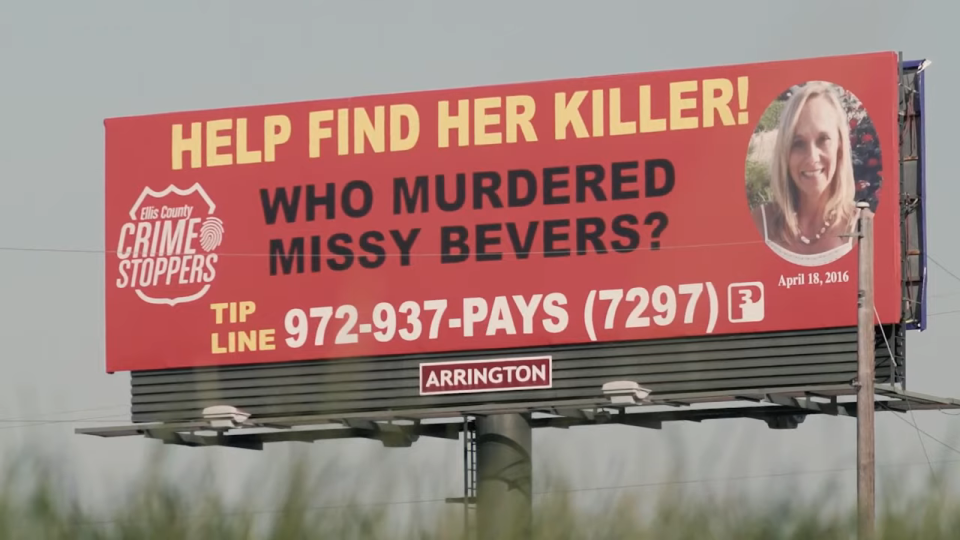 A billboard saying, "Help Find Her Killer! Who Murdered Missy Bevers?"