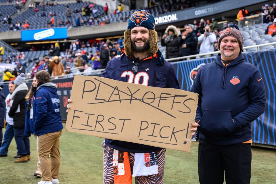 A Chicago Bears fan holds a sign before the Week 18 game against the Minnesota Vikings at Soldier Field.