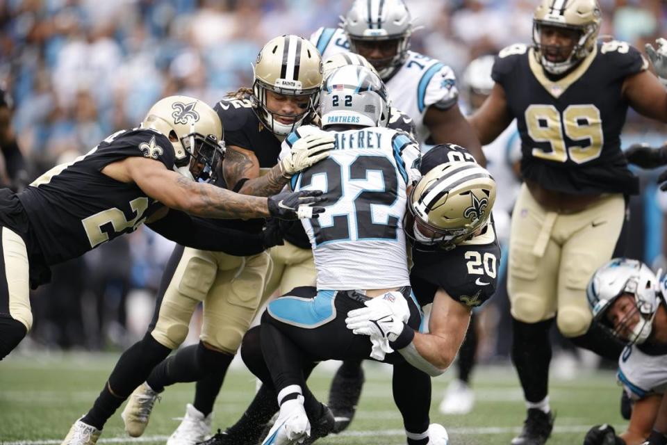 Carolina Panthers Christian McCaffrey is stopped by a host of Saints defenders during a game at Bank of America Stadium in Charlotte, N.C., Sunday, Sept 25, 2022.