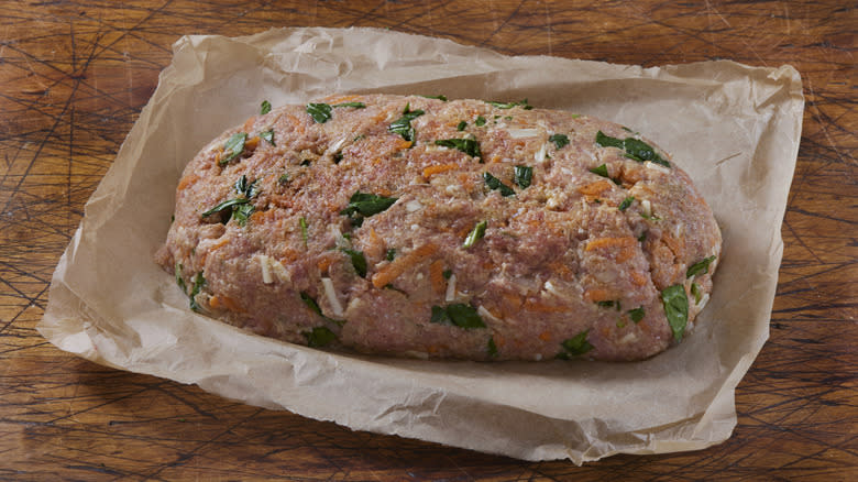 uncooked meatloaf on parchment paper